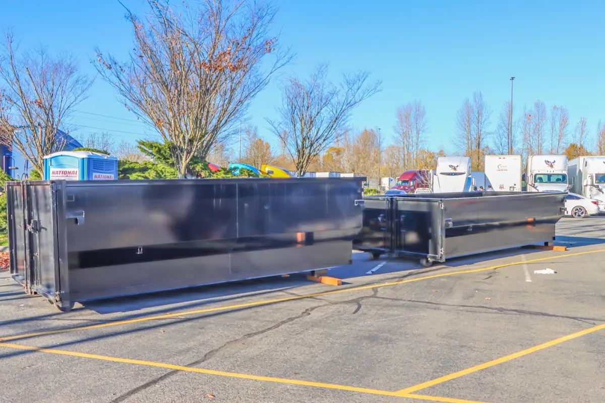 Professional dumpster rental service with roll-off container on residential driveway in Tichigan